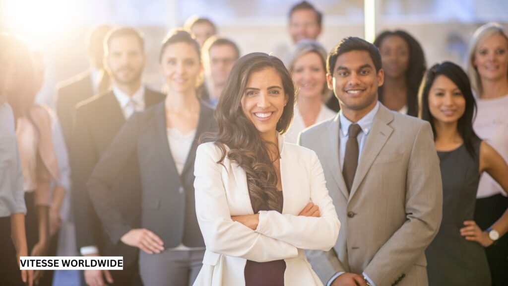 Diverse group of well-dressed corporate event attendees networking and socializing at a professional gathering.